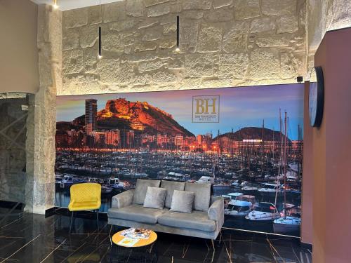 a living room with a large poster of a harbor at Hotel BH San Francisco Alicante in Alicante