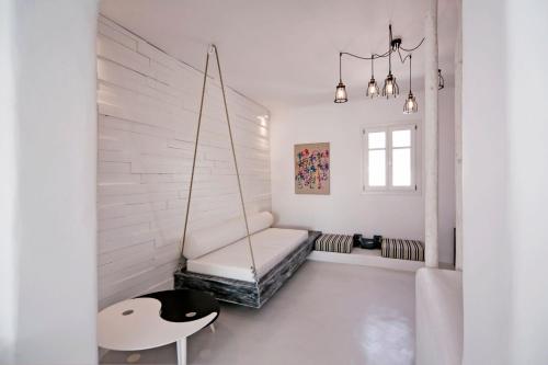 a room with a swing and a chair in it at Luxury Mykonos Villa - 4 Bedrooms - Sea View & Private Pool - Elia in Elia Beach