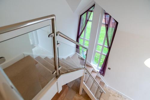 a staircase in a house with a window at Trewhiddle Retreat V17 by Together Travel - Luxury 4-Bedroom Villa in St Austell