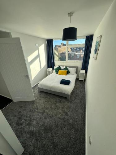 a bedroom with a bed and a large window at Entire 3 Bedroom Apartment in Felixstowe in Felixstowe