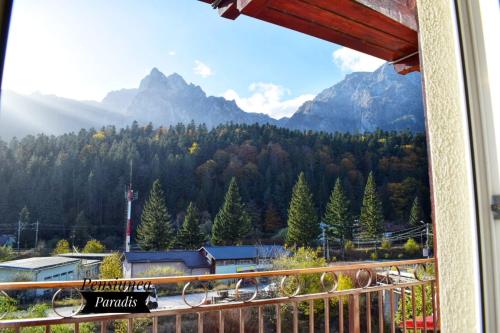 a view of the mountains from a balcony at Pensiunea Paradis in Buşteni