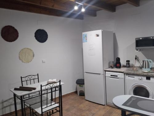 a kitchen with a white refrigerator and a dishwasher at Azahar in Seville