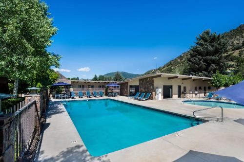 a swimming pool at a resort with mountains in the background at Best Western Antlers in Glenwood Springs