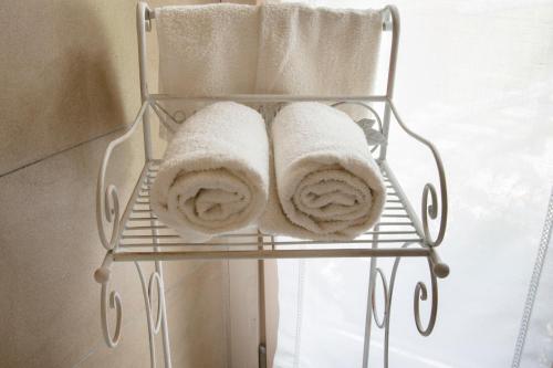 a towel rack with towels on it next to a window at Agriturismo Rossolampone in San Bernardino Verbano