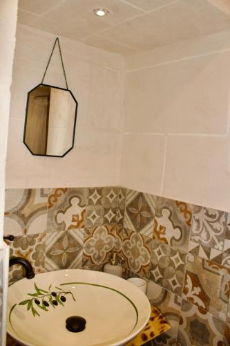 a bathroom with a sink and a chandelier at Nene' in Fasano