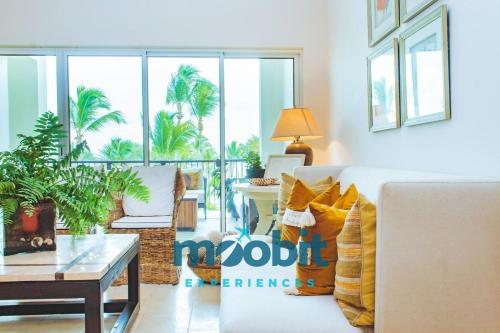 a living room with a couch and a table at Hermoso y perfecto 2 Hab frente al mar en Cap Cana in Punta Cana