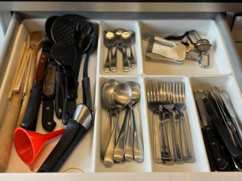 a drawer filled with lots of utensils at T3 Horizon- Face Gare -18 Min Paris in Villemomble