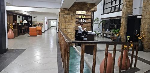 a man walking through a lobby of a store at TLT Condotl E-208 -Near Airport at Kiener Hills Condominium in Mactan