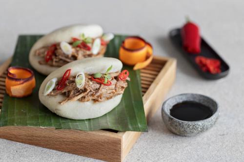 two sandwiches on a wooden plate on a banana leaf at Courtyard by Marriott Biel Bienne in Biel