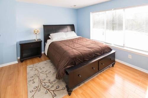 a bedroom with a large bed and a window at The Beacon at Playa Rana in Virginia Beach