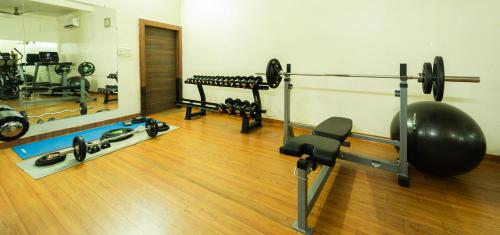 a room with a gym with weights and a mirror at Hotel Royal Palace in Sāgar