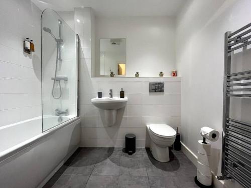 a bathroom with a sink and a toilet and a shower at Modern 1 Bedroom Serviced Apartment - Near City Centre in Doncaster