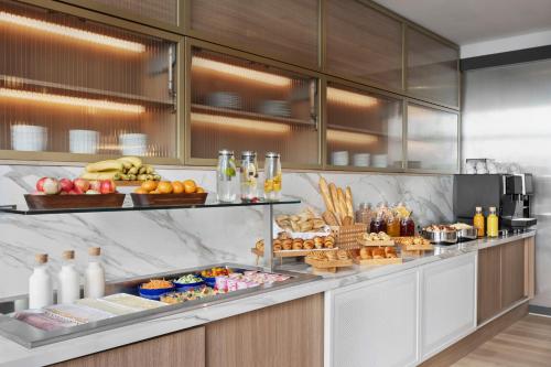 a buffet with a lot of food on it at Courtyard by Marriott Biel Bienne in Biel