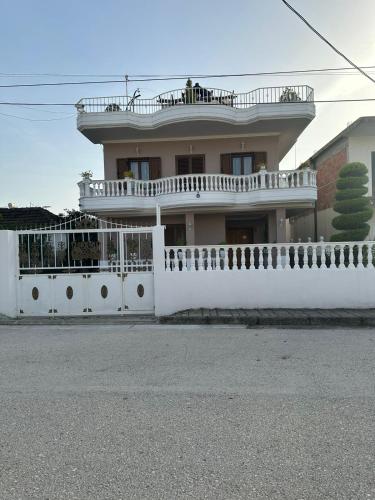 a large white house with a white fence at Villa Mile in Berat