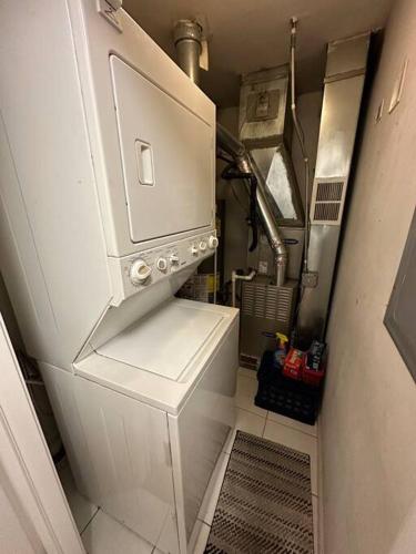 a small kitchen with a stove in a room at 2-Bed 2-Bath Apt - Close to UC w/ Free Parking in Chicago