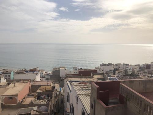 an aerial view of a city and the ocean at Hostel blue house Taghazout in Taghazout