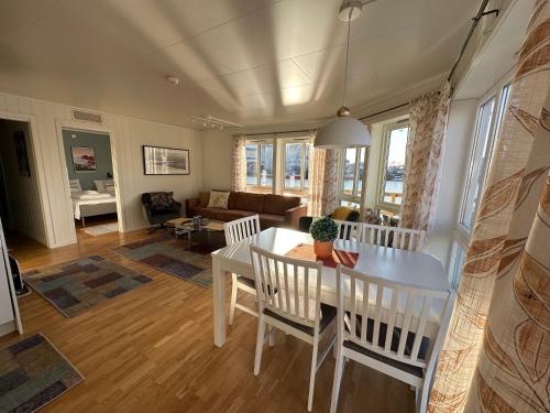a dining room and living room with a table and chairs at Lofoten Rorbuer in Svolv&aelig;r