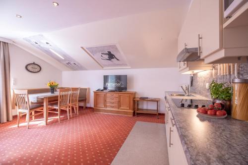 a kitchen with a table and a dining room at Patteriol Apart-Hotel-Garni in Sankt Anton am Arlberg