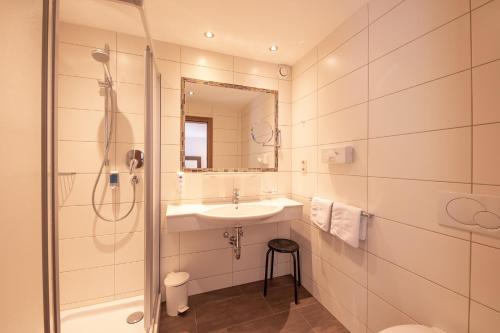 a bathroom with a sink and a shower at Patteriol Apart-Hotel-Garni in Sankt Anton am Arlberg