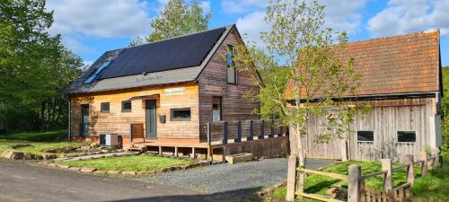 a house with solar panels on top of it at Neu 2023! Chalet Wasserkuppe Whirlpool u. Sauna in Feldbach