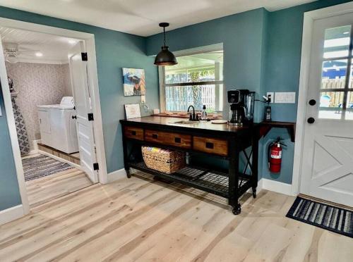 a kitchen with a sink and a counter at Sea la Vie - Beach Town Charm+Newly Renovated in Cocoa Beach