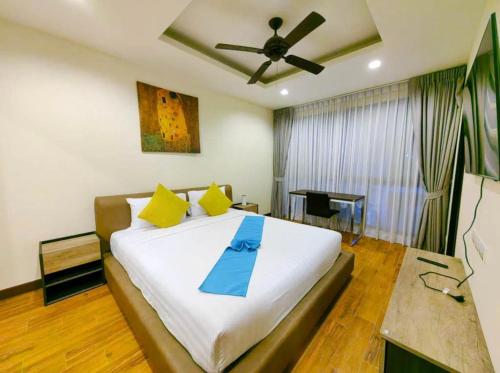 a bedroom with a large bed with a ceiling fan at Laguna Park, BangTao Laguna in Bang Tao Beach