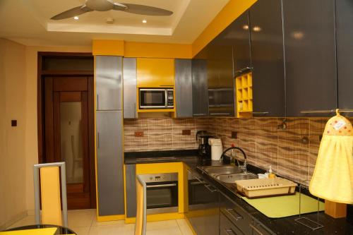 a kitchen with a sink and a counter top at ASK Apartments in Accra