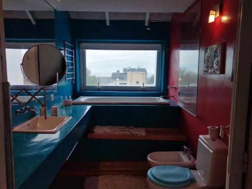 a bathroom with a sink and a toilet and a window at Casa con piscina a 5 minutos del centro in El Challao