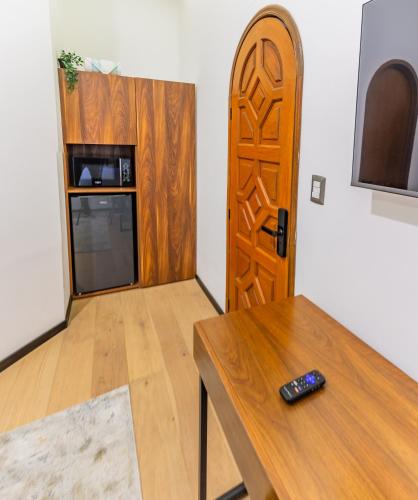 a room with a table and a wooden door at Casa Castillo in Mexico City