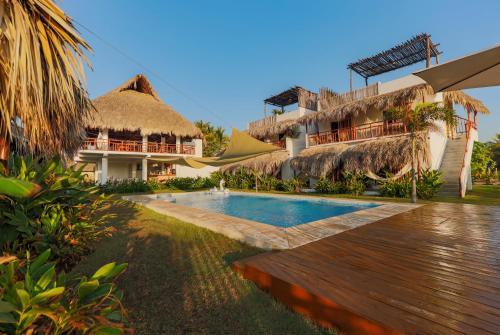 a resort with a swimming pool and a building at Ka&acute;ana Surf in El Pared&oacute;n Buena Vista