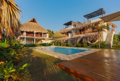 a resort with a swimming pool and a building at Ka´ana Surf in El Paredón Buena Vista