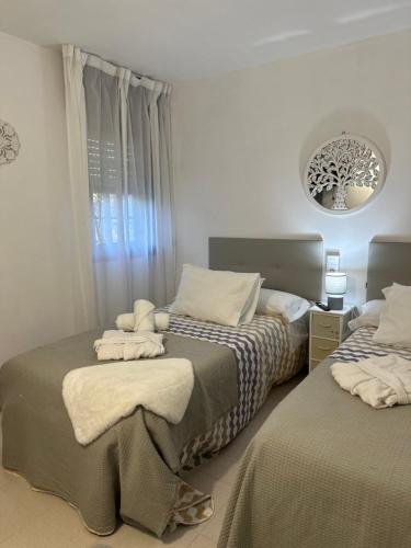 a bedroom with two beds with towels on them at Casa da Rapadoira in Laxoso de Abaixo