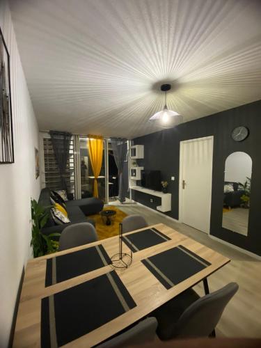 a living room with a wooden table and chairs at Quiet Place in Cayenne