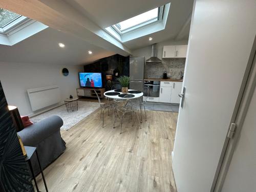 une cuisine et un salon avec une table et des chaises dans l'établissement Un brin de Pampa, à Vienne