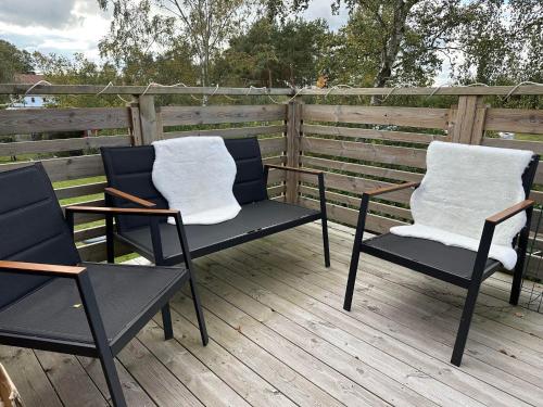 two chairs sitting on top of a wooden deck at Yngsjövång in Yngsjö