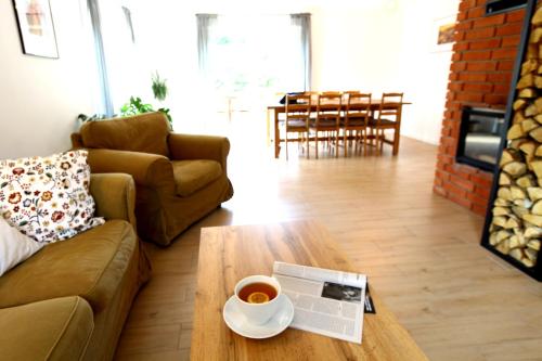 a living room with a coffee table with a cup of coffee at Dobre Miejsce in Międzyzdroje