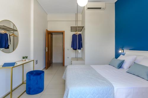 a bedroom with a large bed and a mirror at Centro Y Mar! Central Penthouse with Terrace! in Argostoli