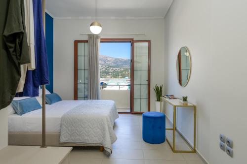 a bedroom with a bed and a large window at Centro Y Mar! Central Penthouse with Terrace! in Argostoli