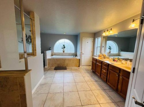 a large bathroom with two sinks and a tub at Tropical Riverfront Paradise - Gorgeous Sunset Views in Merritt Island