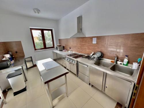 a kitchen with stainless steel appliances and a sink at Willa Brancon in Babimost