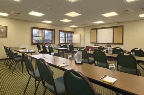 a conference room with tables and chairs and a whiteboard at Days Inn Hershey in Hershey