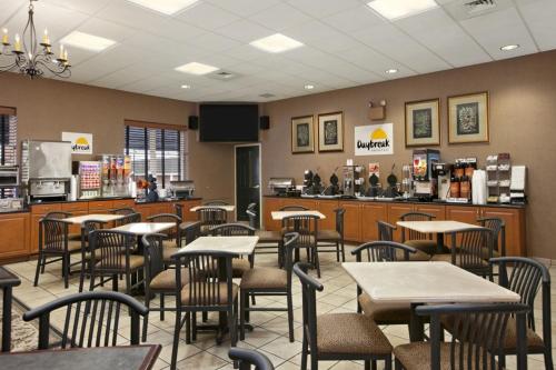a restaurant with tables and chairs and a bar at Days Inn Hershey in Hershey