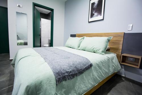 a bedroom with a large bed in a room at Nidah Condominios in Durango