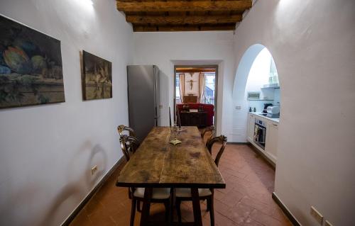a kitchen with a table and chairs in a room at Acacia Firenze - Adelfa in Florence