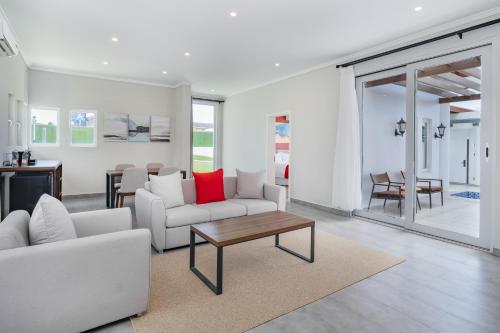 a living room with a couch and a table at Ramada by Wyndham St Kitts Resort in Newton Ground