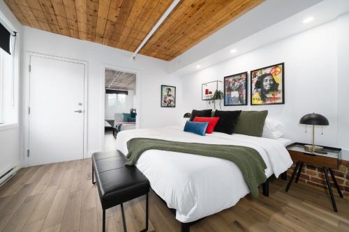 a bedroom with a large bed and a wooden ceiling at Heaven's Garden / / Luxury penthouse downtown in Quebec City