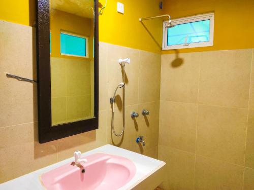 a bathroom with a pink sink and a shower at Yala Bay Holiday Resort in Tissamaharama