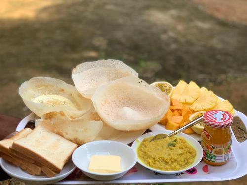 une assiette de nourriture avec du pain, du fromage et des plongées dans l'établissement Summer Time Hiriketiya, à Dikwella