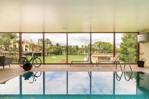 a house with a pool with a bike on the deck at Casa do Espigueiro in Chaves