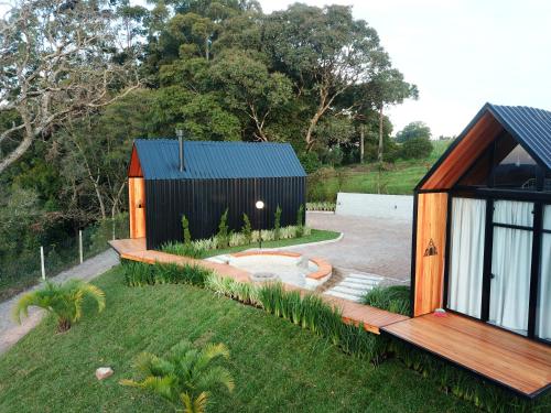 a small house with a deck and a yard at Alta Vista Cabanas in Garibaldi